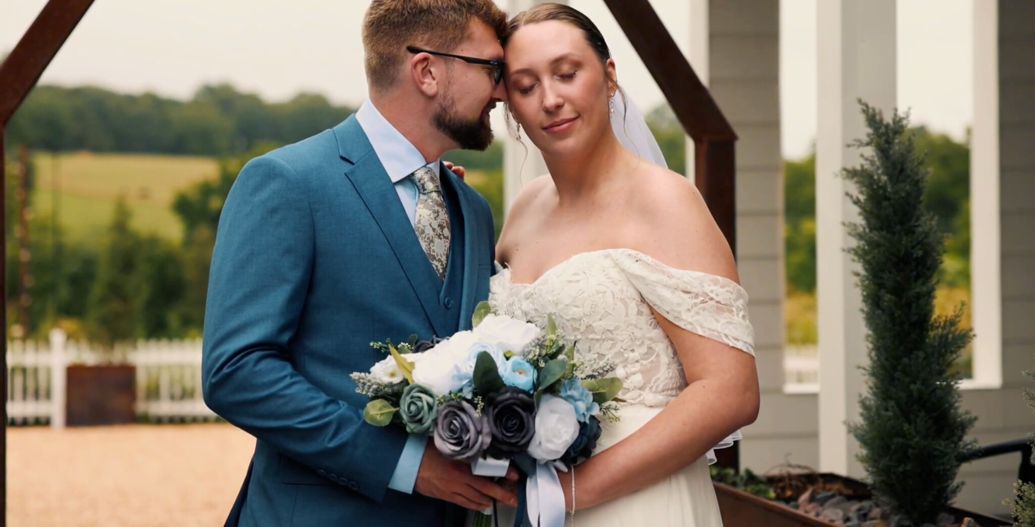 Emily and August sharing an intimate portrait beside their venue