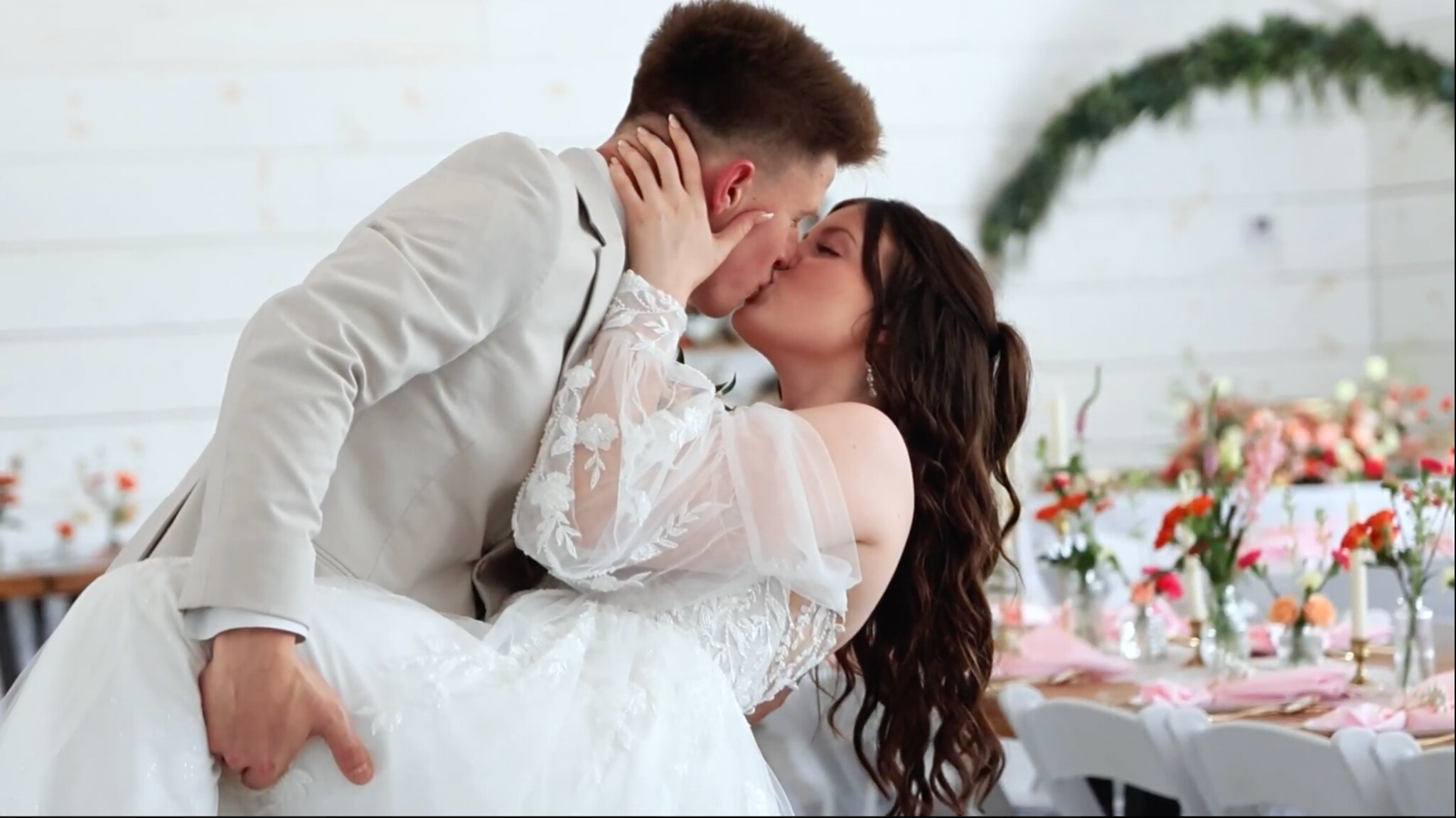 Grace and Bryan sharing a celebratory kiss at their wedding reception