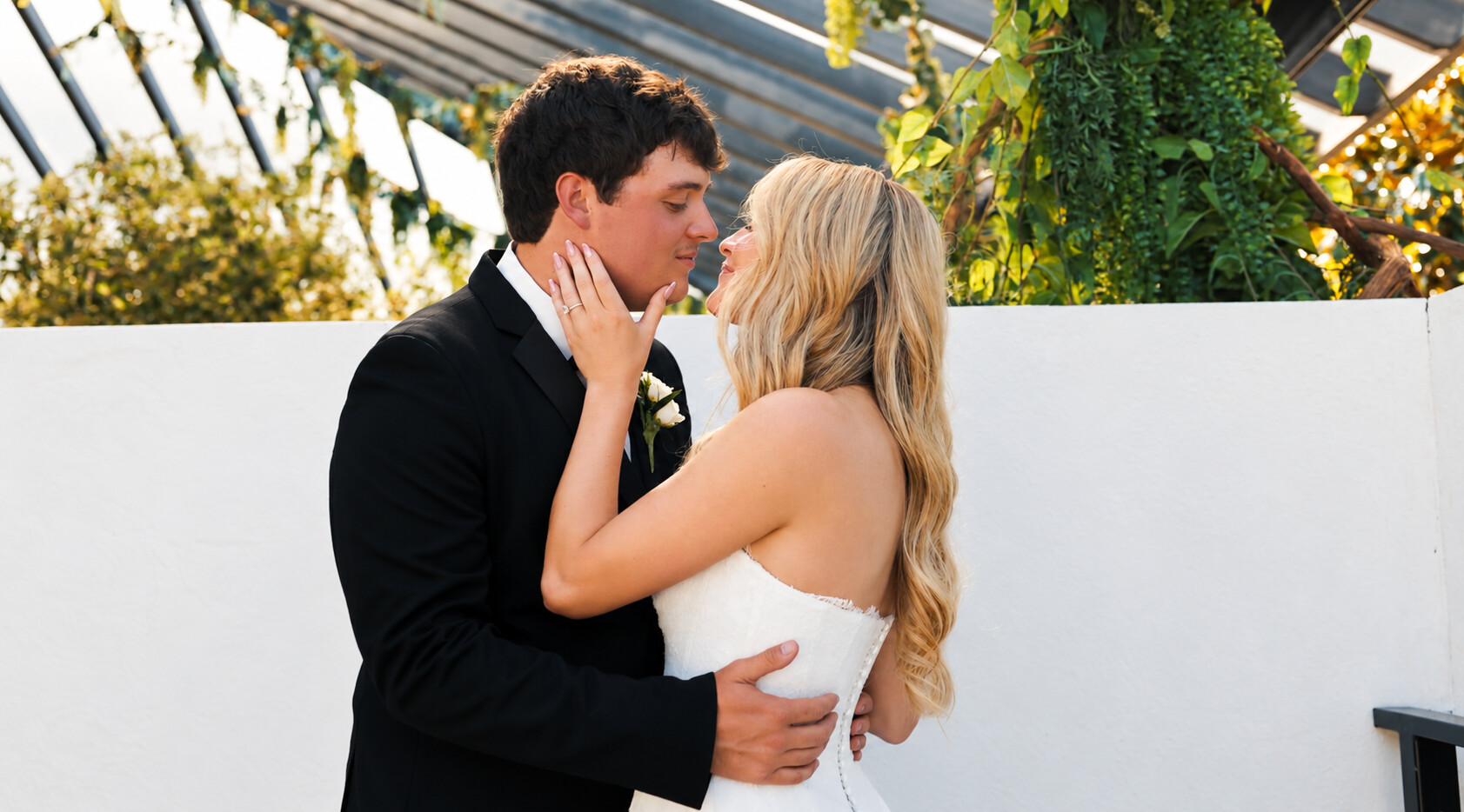 Lexie and Jonathan sharing a quiet portrait beneath a glass garden canopy